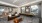 Clubhouse lounge with seating area, kitchen, and shuffleboard